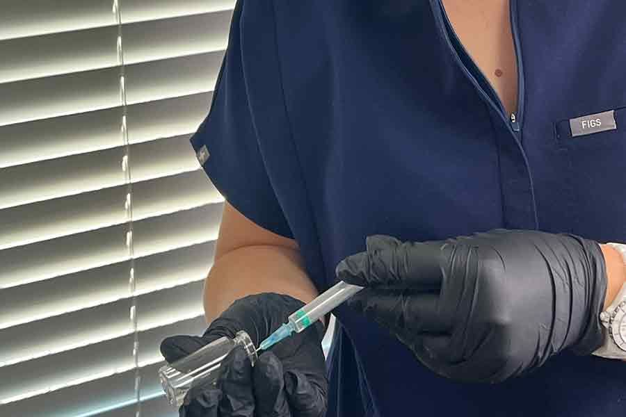 woman filling an injection with skin booster sereum