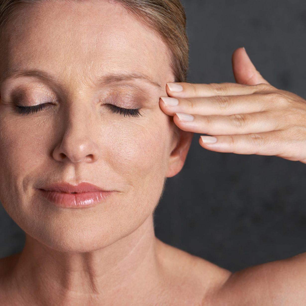 mature woman with her hands on the side of her face
