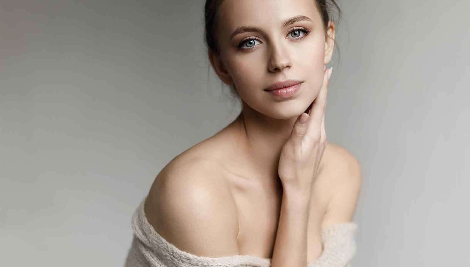 beautiful young woman with her hand on her face