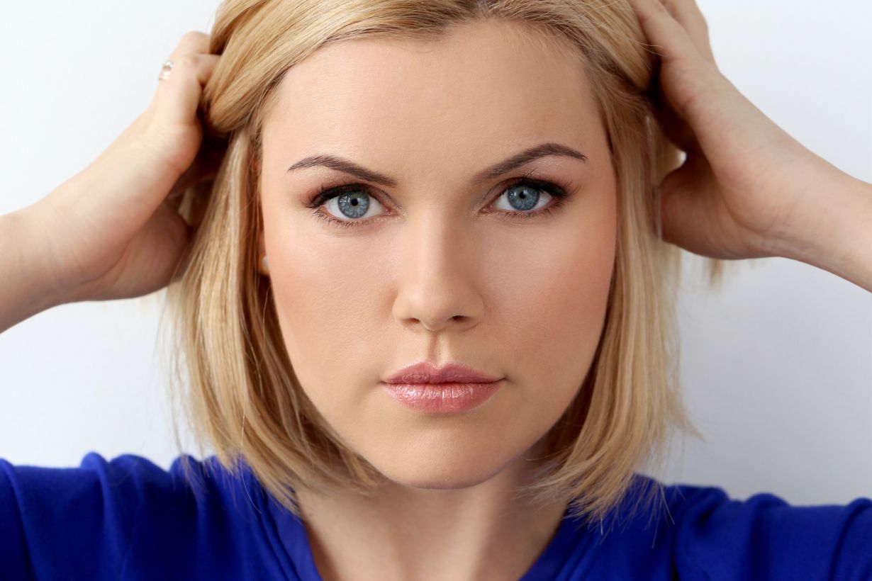 girl with perfect skin holding her hair