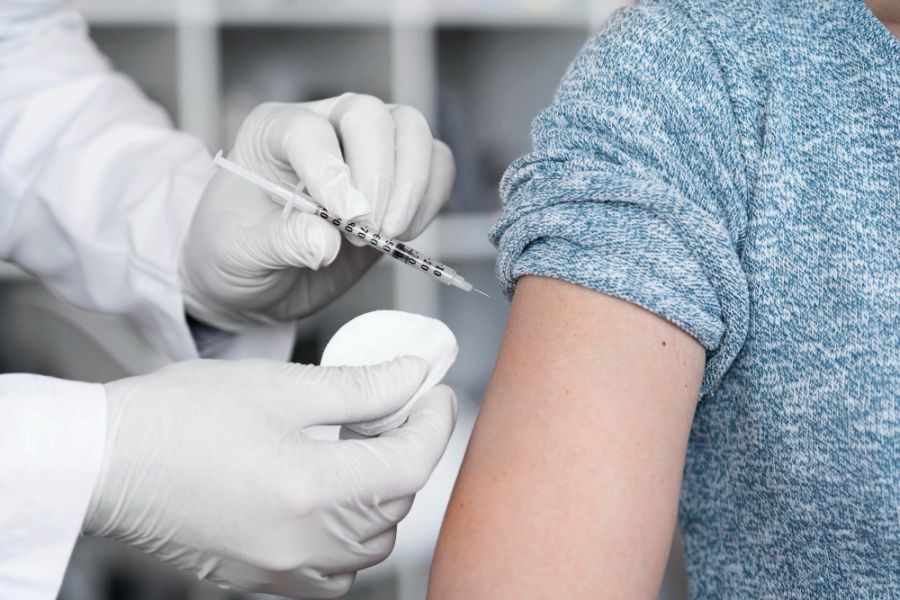 woman receiving a vitamin injection in her arm